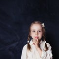 ÃÂ¡urious child thinking. Little girl on chalk board background